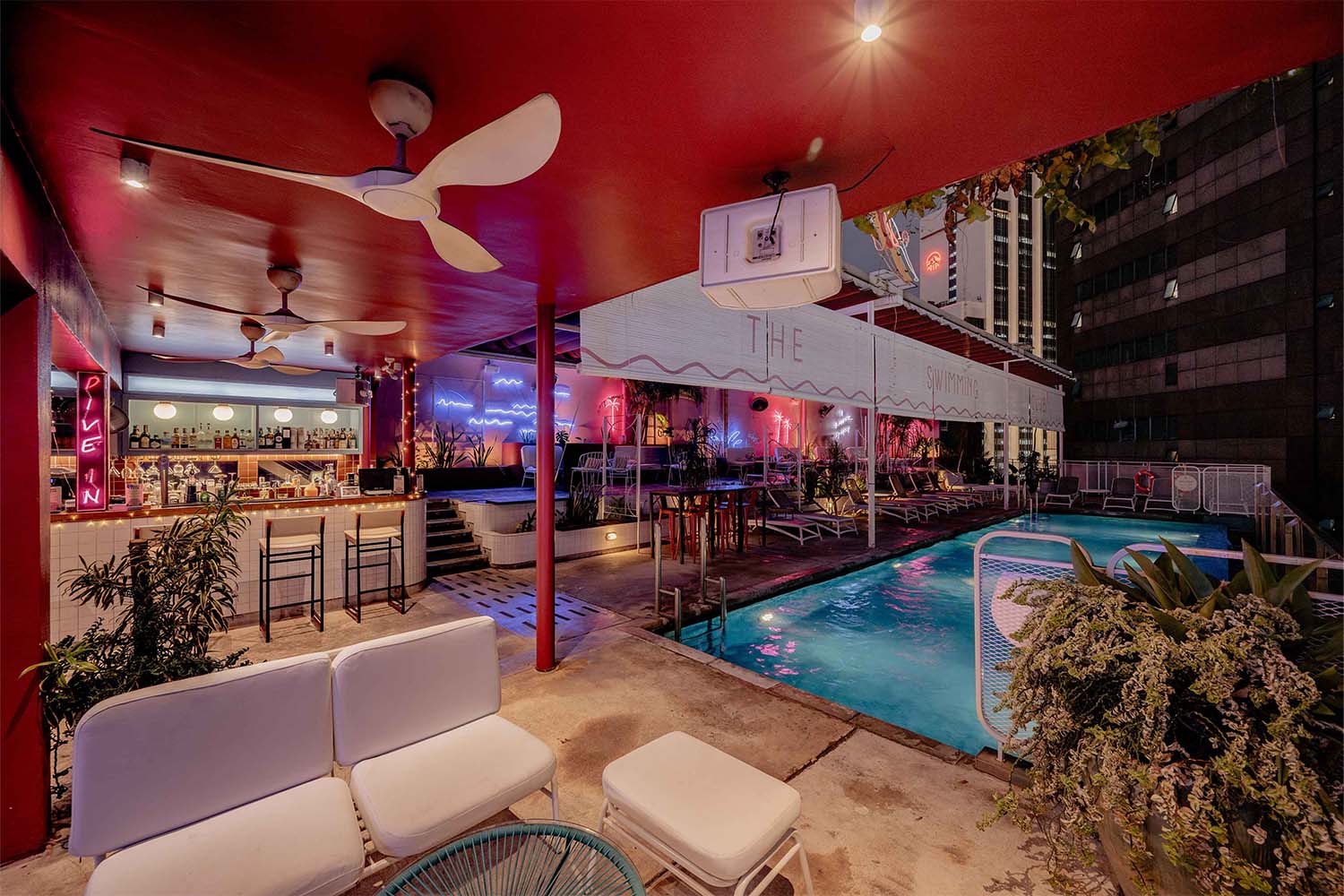 Swimming Club by night – Moonlight, cocktails, and rooftop magic.